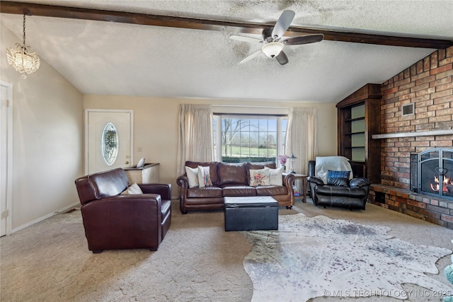 living area with vaulted ceiling with beams, carpet, a fireplace, a textured ceiling, and a ceiling fan