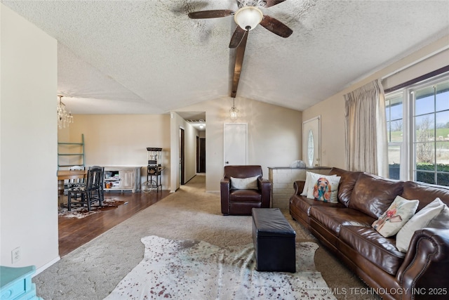 living room featuring a textured ceiling, vaulted ceiling with beams, and ceiling fan with notable chandelier