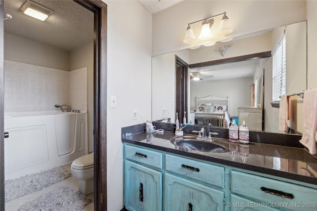 full bath featuring tile patterned floors, ceiling fan, vanity, a bath, and a textured ceiling