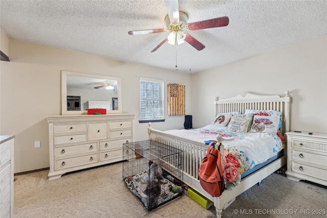 bedroom featuring carpet flooring, a textured ceiling, and ceiling fan