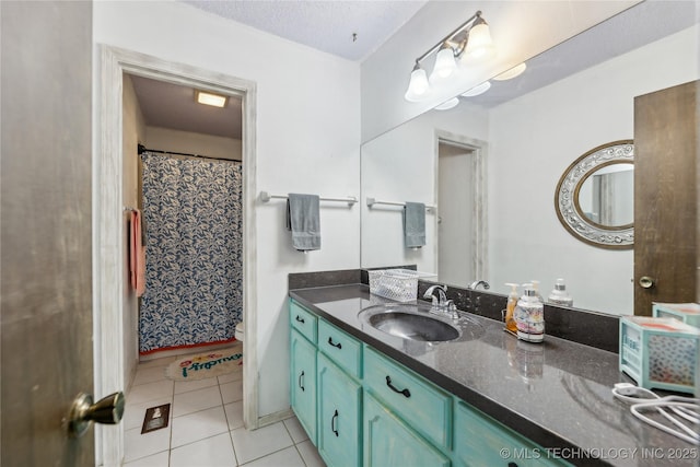 bathroom with vanity, tile patterned floors, and a textured ceiling