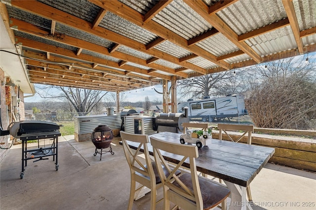 view of patio / terrace with area for grilling, a fire pit, and outdoor dining area