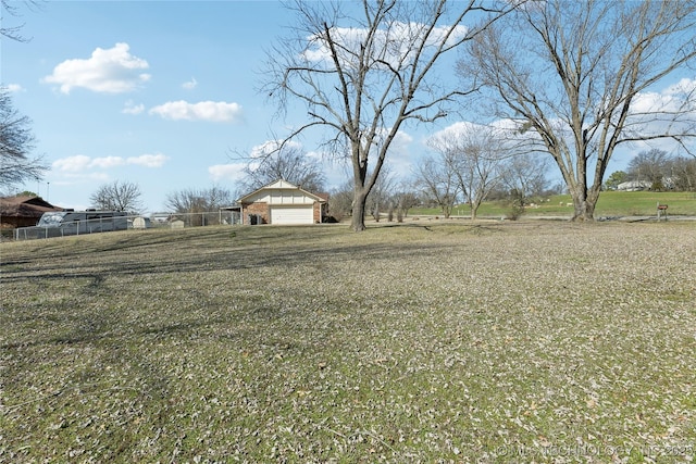 view of yard featuring an outdoor structure and fence