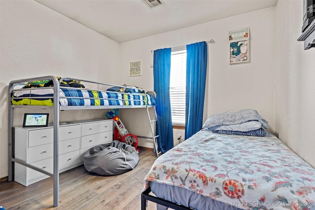 bedroom with wood finished floors and visible vents