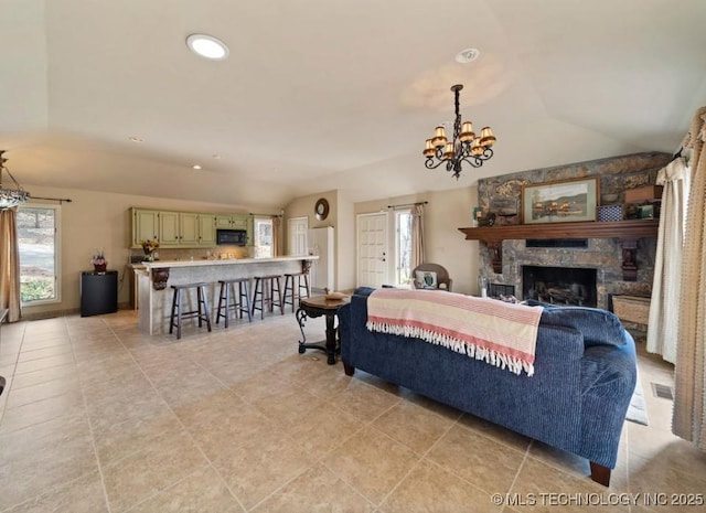 33861 S 4507th Rd, Afton, OK 74331 - living room with vaulted ceiling, healthy amount of natural light, a fireplace, a chandelier, and light tile patterned flooring