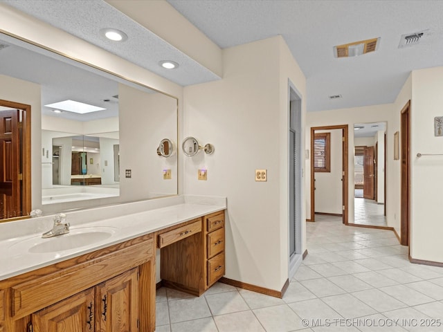 full bathroom with tile patterned flooring, visible vents, vanity, and baseboards