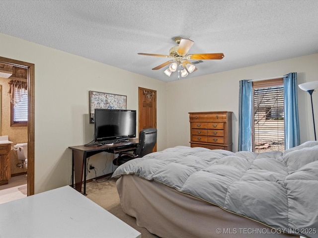 bedroom with light carpet, a textured ceiling, and a ceiling fan