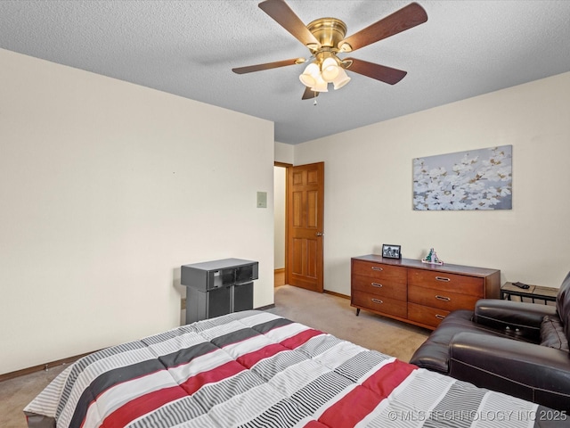 bedroom featuring a textured ceiling, a ceiling fan, baseboards, and light carpet