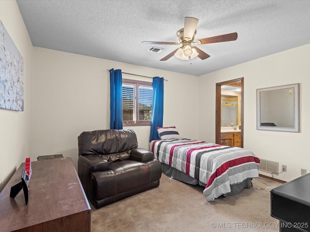 bedroom featuring visible vents, a textured ceiling, and carpet floors