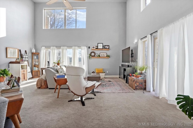 living room with baseboards, carpet, a healthy amount of sunlight, and ceiling fan