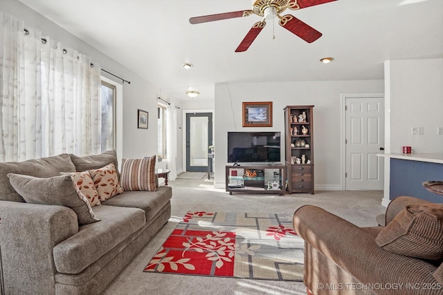 living room with light colored carpet, baseboards, and a ceiling fan