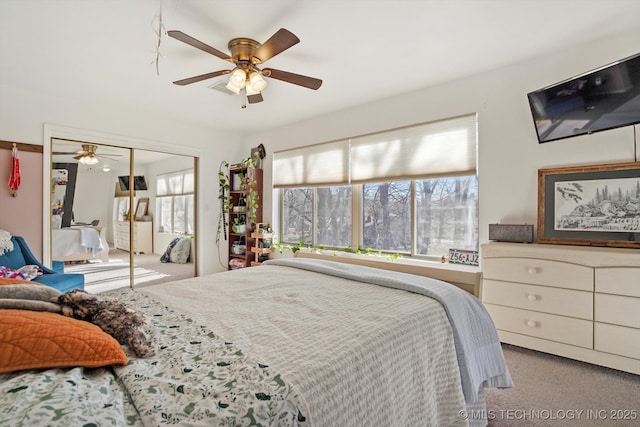 bedroom with a closet, ceiling fan, and carpet floors