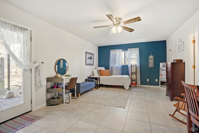 bedroom with light tile patterned floors, baseboards, and ceiling fan