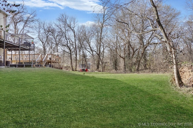 view of yard featuring stairway and a deck