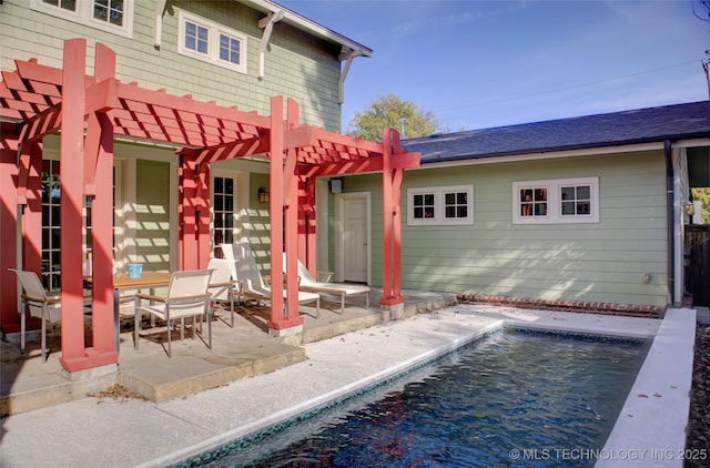 rear view of property with an outdoor pool, a patio, a shingled roof, and a pergola