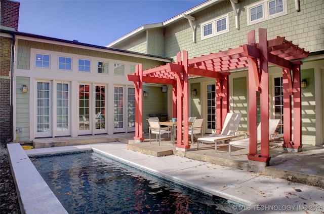 rear view of property featuring a patio, an outdoor pool, and a pergola