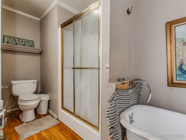 35575 W 87th Pl S, Mannford, OK 74044 - bathroom with crown molding, toilet, wood finished floors, a soaking tub, and a stall shower