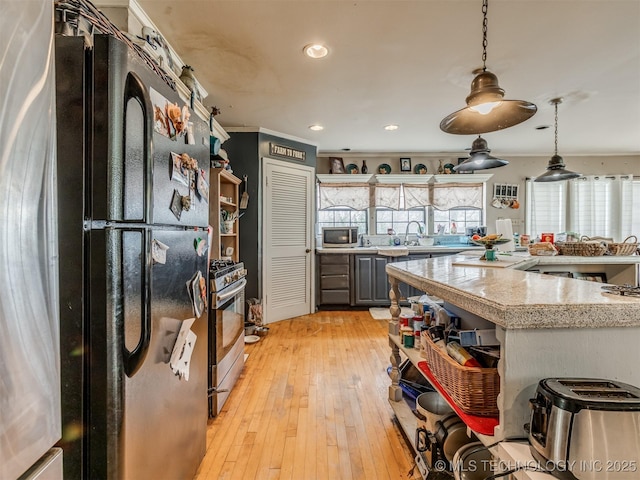35575 W 87th Pl S, Mannford, OK 74044 - kitchen featuring open shelves, pendant lighting, light wood-type flooring, recessed lighting, and appliances with stainless steel finishes