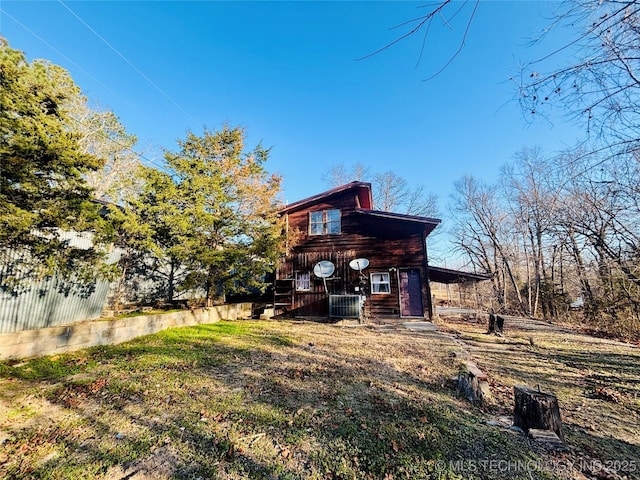 back of house with central AC unit