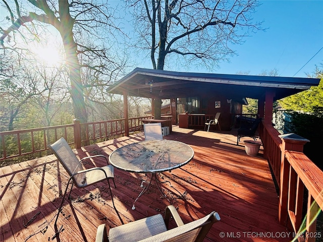 deck with outdoor dining area