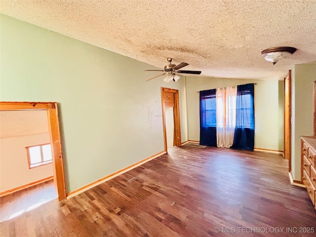 spare room featuring a ceiling fan, a textured ceiling, wood finished floors, and a healthy amount of sunlight