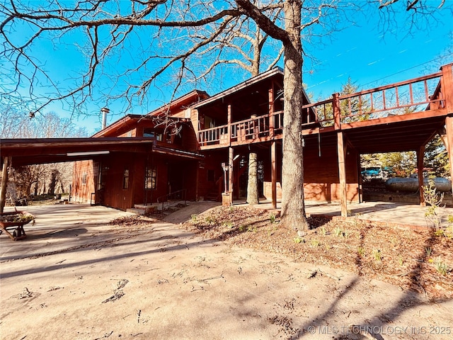 view of front facade with an attached carport and concrete driveway