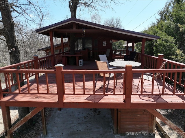 wooden terrace with outdoor dining area