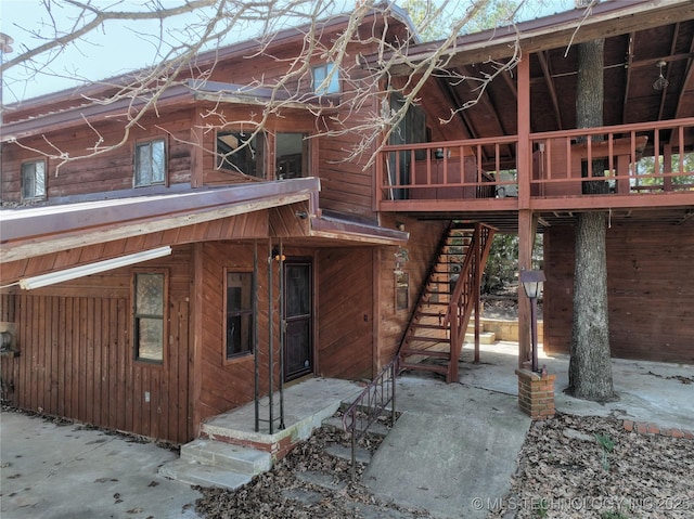 rear view of house featuring stairway