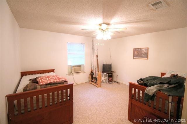 6786 Red Oak, Kingston, OK 73439 - bedroom with visible vents, a ceiling fan, a textured ceiling, cooling unit, and carpet floors