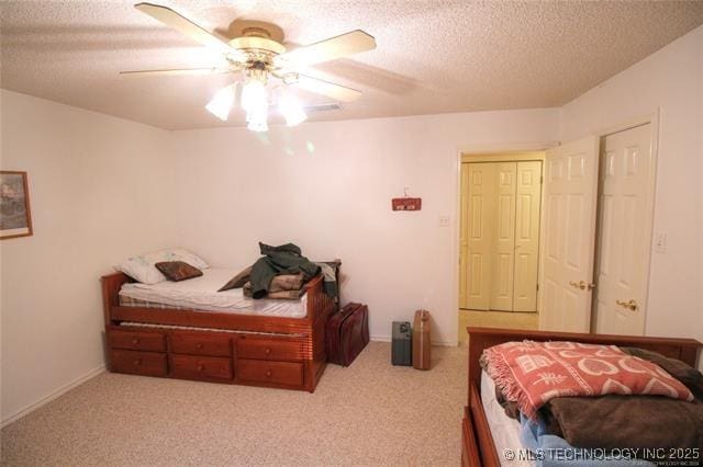 6786 Red Oak, Kingston, OK 73439 - bedroom with carpet floors, a textured ceiling, and a ceiling fan