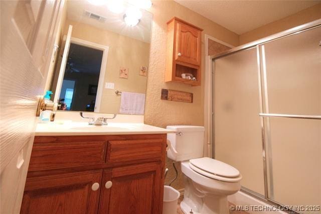 6786 Red Oak, Kingston, OK 73439 - bathroom with visible vents, toilet, a stall shower, and vanity