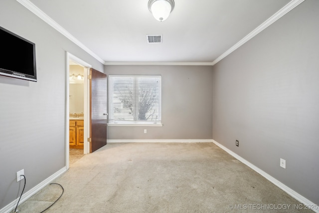 unfurnished bedroom featuring visible vents, ornamental molding, ensuite bathroom, carpet flooring, and baseboards