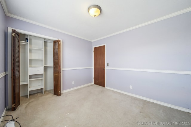 unfurnished bedroom with a closet, baseboards, carpet, and ornamental molding