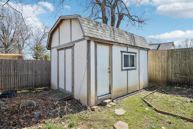 view of shed with a garden and a fenced backyard