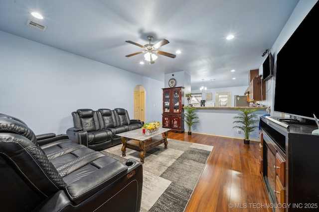 living area with a ceiling fan, visible vents, dark wood finished floors, recessed lighting, and arched walkways