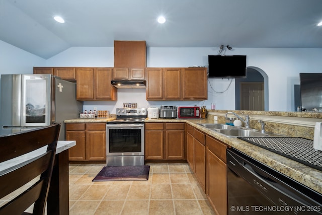 kitchen with recessed lighting, a sink, under cabinet range hood, appliances with stainless steel finishes, and brown cabinets