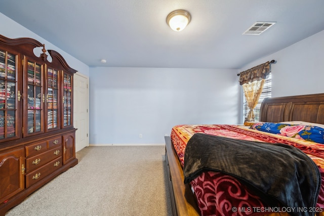 carpeted bedroom with baseboards and visible vents