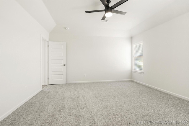 empty room with baseboards, carpet floors, visible vents, and a ceiling fan