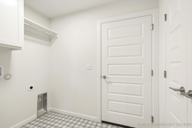 clothes washing area with electric dryer hookup, baseboards, and cabinet space