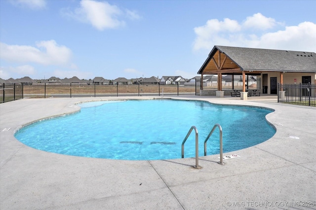 community pool with a gazebo, a patio, and fence