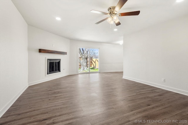 unfurnished living room featuring dark wood-style floors, baseboards, a ceiling fan, a fireplace, and recessed lighting