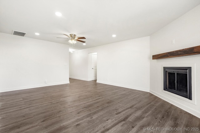 unfurnished living room with a ceiling fan, dark wood-style floors, visible vents, recessed lighting, and a fireplace