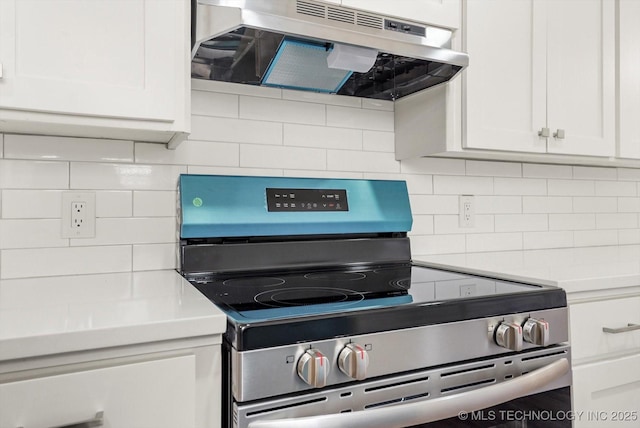 kitchen with decorative backsplash, light countertops, stainless steel range with electric stovetop, white cabinets, and under cabinet range hood