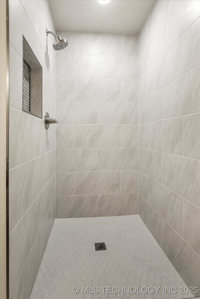 bathroom with tiled shower