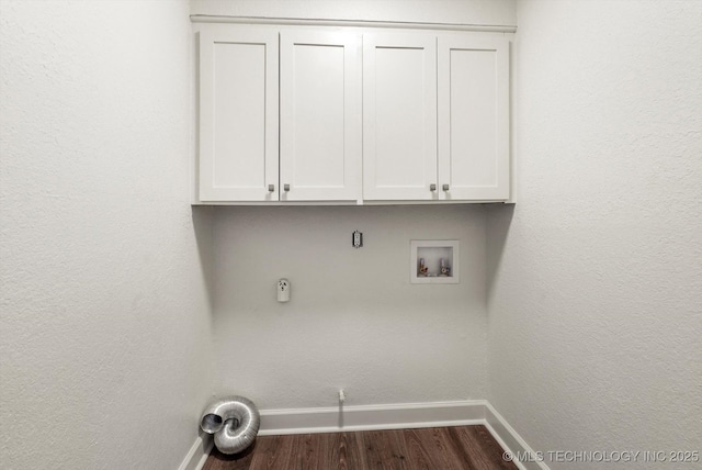 laundry area with washer hookup, cabinet space, baseboards, and dark wood-style flooring