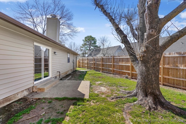 view of yard featuring entry steps, a patio, and a fenced backyard