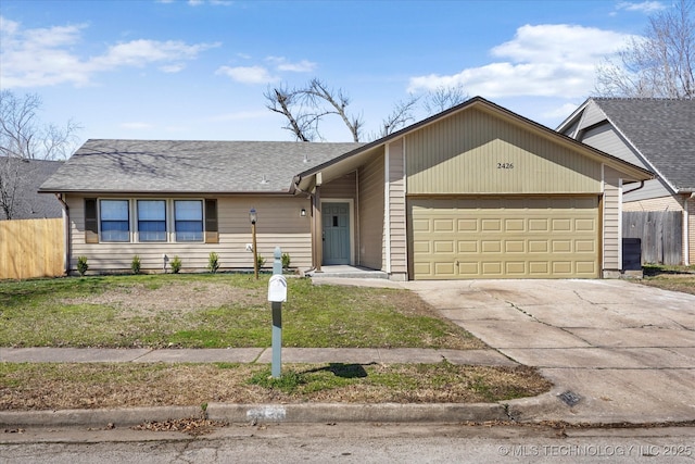 view of front of property with fence, a garage, and driveway