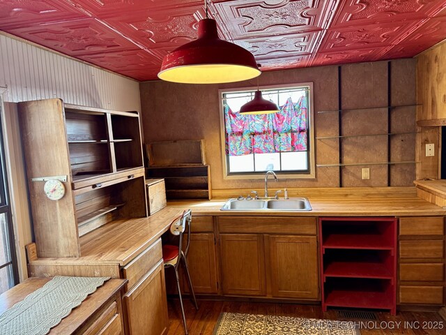 707 E 15th St, Okmulgee, OK 74447 - kitchen featuring an ornate ceiling, brown cabinetry, wood finished floors, decorative light fixtures, and open shelves
