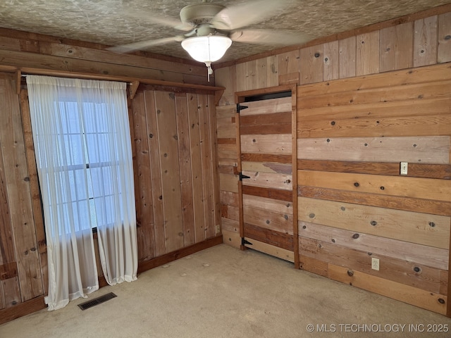 707 E 15th St, Okmulgee, OK 74447 - unfurnished room with wooden walls, light carpet, and a ceiling fan