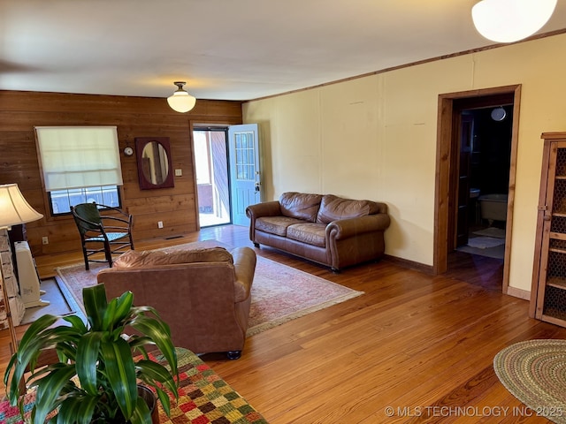 707 E 15th St, Okmulgee, OK 74447 - living area with light wood-style flooring, wooden walls, and crown molding